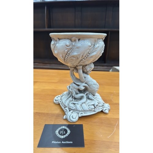 331 - Ornate glazed porcelain tazza with shell-form bowl supported by a cherub on rocaille base, underside... 