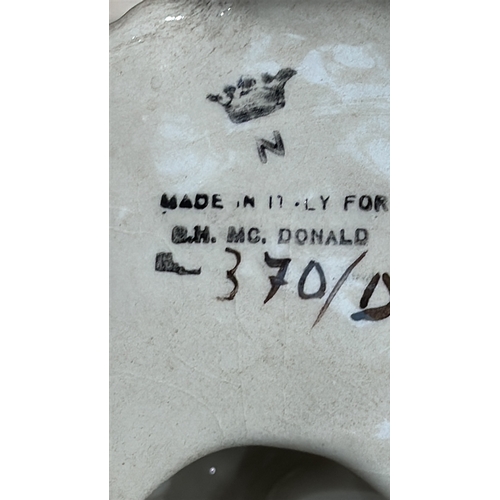 331 - Ornate glazed porcelain tazza with shell-form bowl supported by a cherub on rocaille base, underside... 