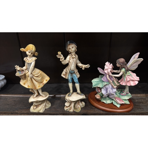 352 - Set of three figural ornaments: Italian “Depose Italy” painted composition figures of a barefoot gir... 