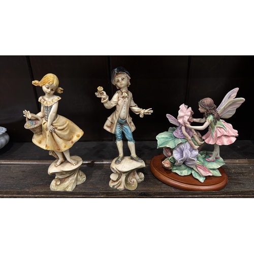 352 - Set of three figural ornaments: Italian “Depose Italy” painted composition figures of a barefoot gir... 