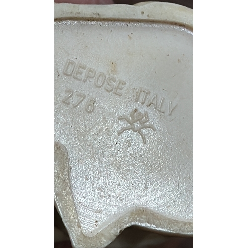 352 - Set of three figural ornaments: Italian “Depose Italy” painted composition figures of a barefoot gir... 