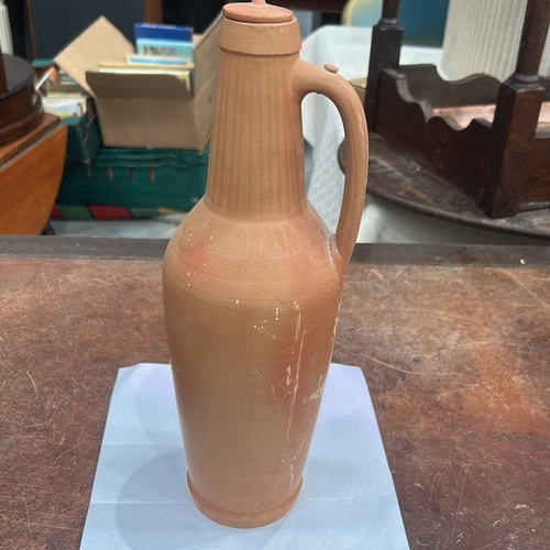 413 - Terracotta handled ewer with domed knop lid, incised vertical fluting to neck and geometric band to ... 