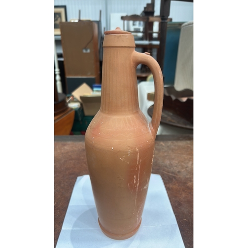413 - Terracotta handled ewer with domed knop lid, incised vertical fluting to neck and geometric band to ... 