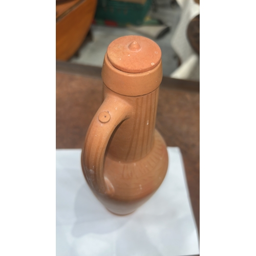 413 - Terracotta handled ewer with domed knop lid, incised vertical fluting to neck and geometric band to ... 
