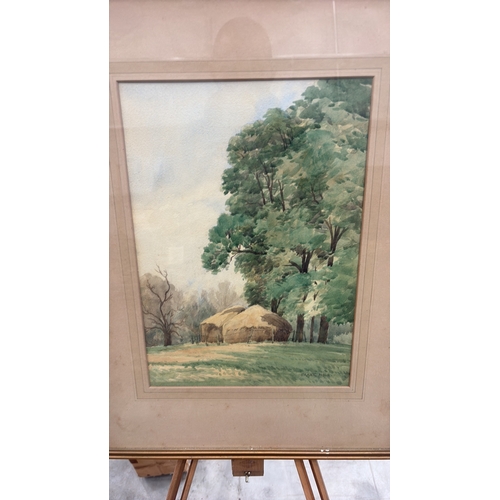 450 - Framed watercolour landscape depicting haystacks beneath mature trees, signed lower right “Frank Hol... 
