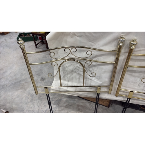 467 - Pair of tubular brass-finish single bed headboards, each with scrolled openwork panels and urn finia... 