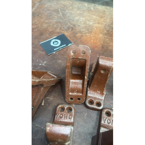 178 - Set of 6 brown-painted cast iron bed-rail angle brackets, each embossed 