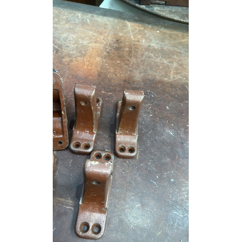178 - Set of 6 brown-painted cast iron bed-rail angle brackets, each embossed 