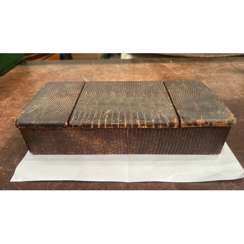 179 - Rectangular wooden trinket box clad in lizard-pattern leather, three hinged lids opening to a partit... 
