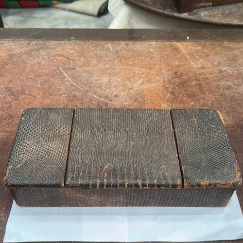 179 - Rectangular wooden trinket box clad in lizard-pattern leather, three hinged lids opening to a partit... 
