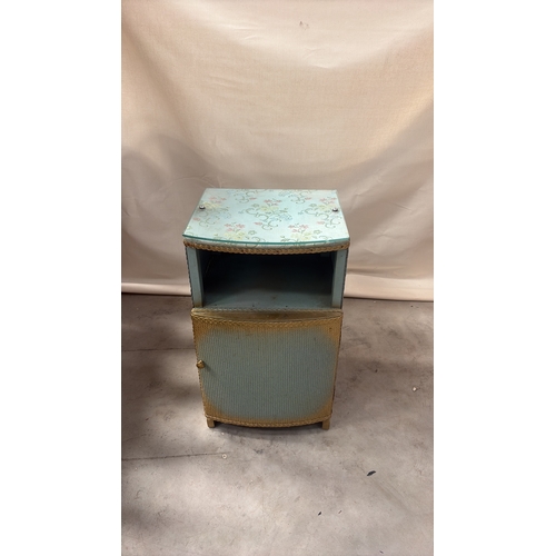 181 - Light blue painted wood and woven wicker bedside cabinet, floral fabric top beneath glass, rope edgi... 