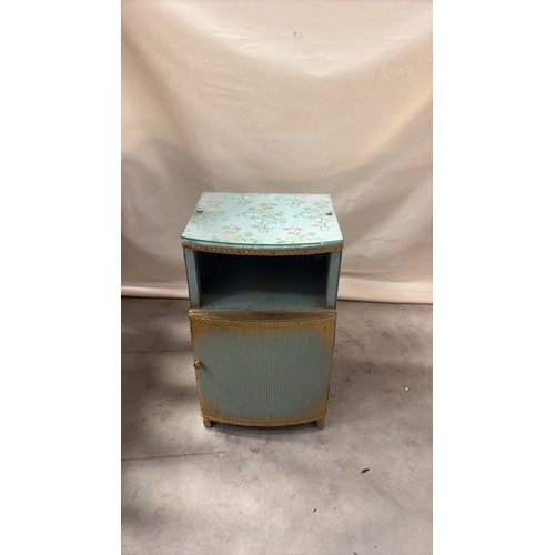 181 - Light blue painted wood and woven wicker bedside cabinet, floral fabric top beneath glass, rope edgi... 