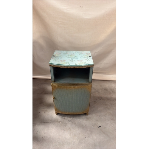 181 - Light blue painted wood and woven wicker bedside cabinet, floral fabric top beneath glass, rope edgi... 