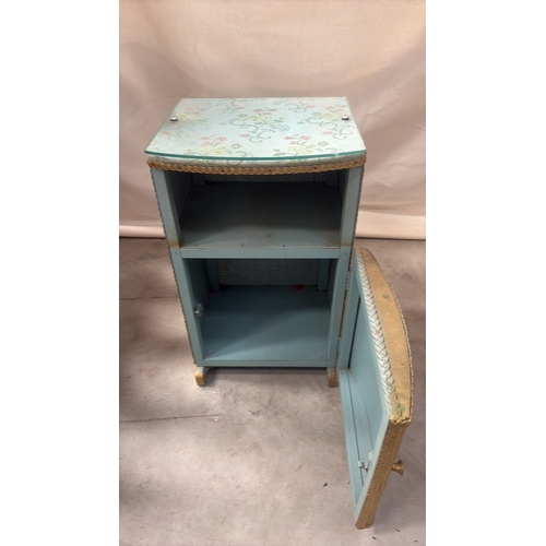 181 - Light blue painted wood and woven wicker bedside cabinet, floral fabric top beneath glass, rope edgi... 