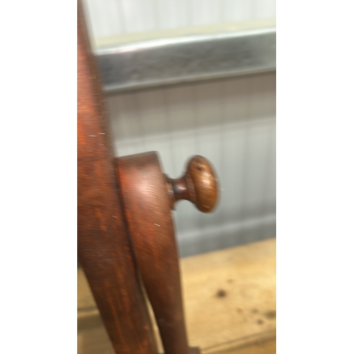 206 - Mahogany swing dressing-table mirror, arched plate within turned supports above a shaped base fitted... 