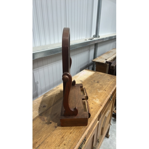 206 - Mahogany swing dressing-table mirror, arched plate within turned supports above a shaped base fitted... 