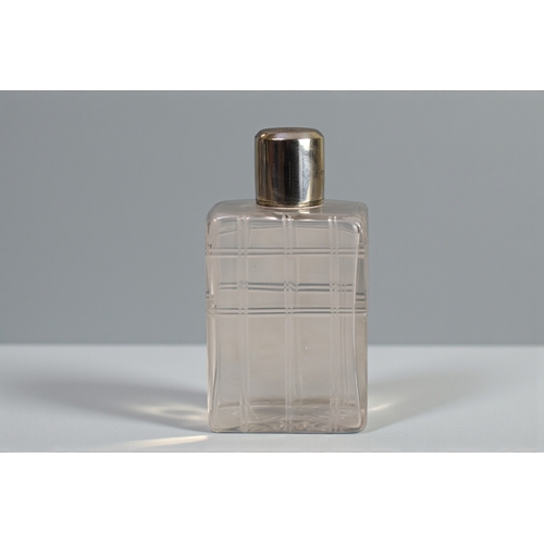 226 - A pair of Mappin & Webb silver topped scent bottles.London, 1946 engine turned tops. Together wi... 