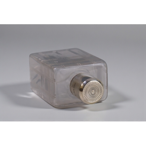 226 - A pair of Mappin & Webb silver topped scent bottles.London, 1946 engine turned tops. Together wi... 