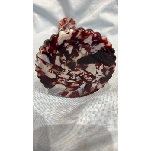 114 - Spiral-moulded candlestick of marbled red, white and cream art glass, the fluted stem rising from a ... 