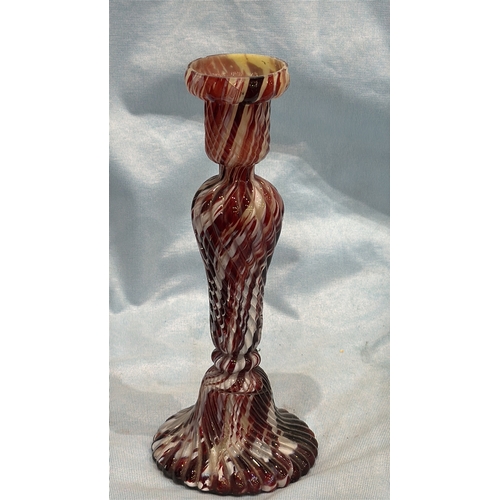114 - Spiral-moulded candlestick of marbled red, white and cream art glass, the fluted stem rising from a ... 