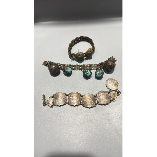 131 - Group of three Chinese export-style gilt metal bracelets: braided rope filigree example with green c... 