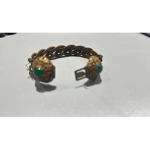 131 - Group of three Chinese export-style gilt metal bracelets: braided rope filigree example with green c... 