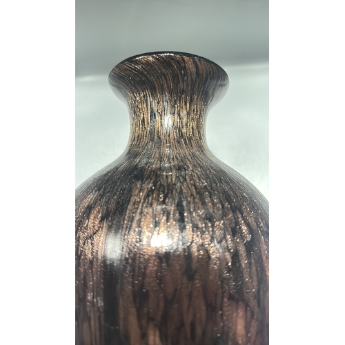 132 - Black and copper-toned blown art glass vase with flared rim, slender neck and ovoid body, decorated ... 