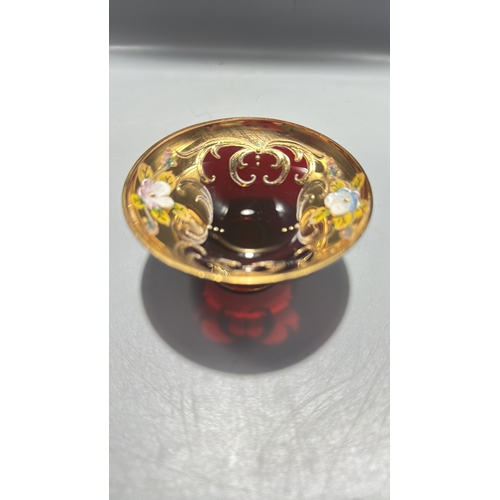 136 - Ruby red Italian glass miniature pedestal bowl, richly gilt with scrollwork and applied polychrome e... 