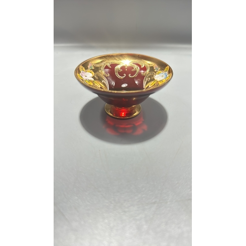 136 - Ruby red Italian glass miniature pedestal bowl, richly gilt with scrollwork and applied polychrome e... 