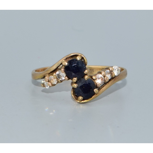 106 - 9ct gold ladies twin stone sapphire ring in a twist design with clear stone enhancement size Q 2.4gr... 