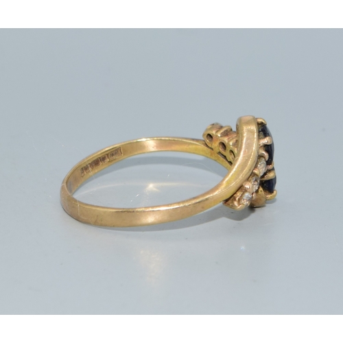 106 - 9ct gold ladies twin stone sapphire ring in a twist design with clear stone enhancement size Q 2.4gr... 