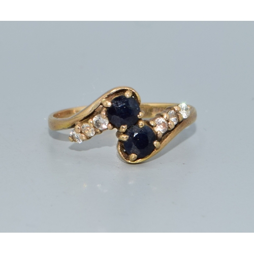 106 - 9ct gold ladies twin stone sapphire ring in a twist design with clear stone enhancement size Q 2.4gr... 