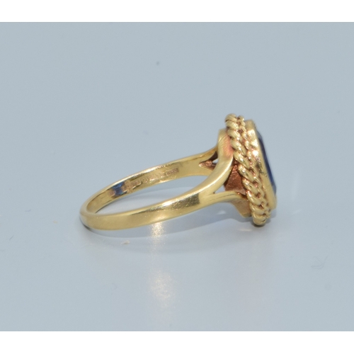 198 - 9ct gold ladies intense Royal Blue colour gem stone mimicking a Ceylon sapphire held in a scrolled e... 