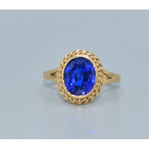 198 - 9ct gold ladies intense Royal Blue colour gem stone mimicking a Ceylon sapphire held in a scrolled e... 