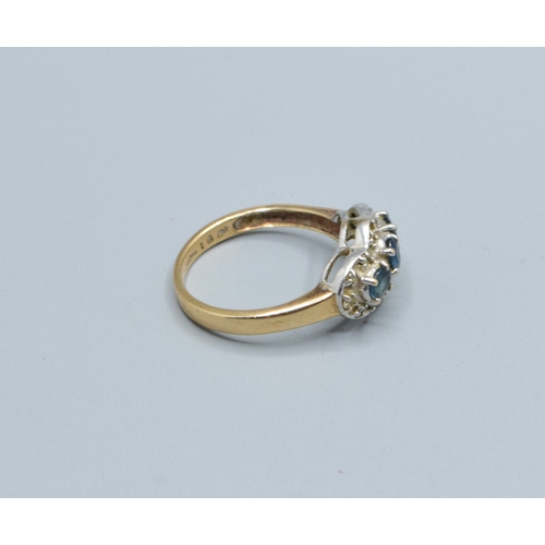 256 - 9ct gold ladies triple Tanzanite and Diamond graduated halo design ring size N, 3.5grams