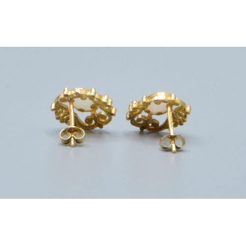 2 - 9ct gold Opal stud earrings with scroll work setting head size 14x9mm