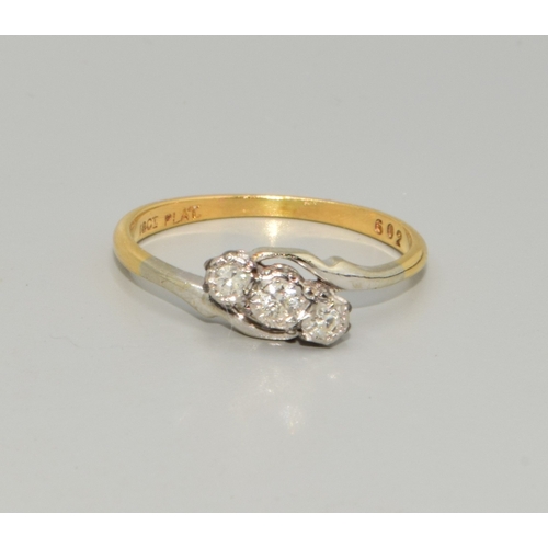 319 - 18ct gold and Platinum ladies 3 stone twist Diamond ring estimated as 0.25cts size M