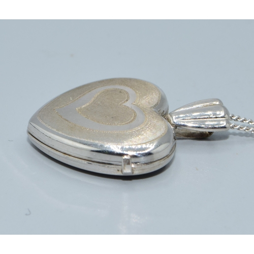 169 - 9ct white gold heart picture locket on a 9ct white gold chain of 44cm long with a plain cartouche a ... 