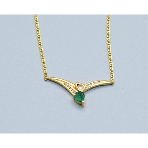 244 - 18ct gold ladies Diamond and Emerald cross over pendant necklace the pendant measures 30mm across by... 