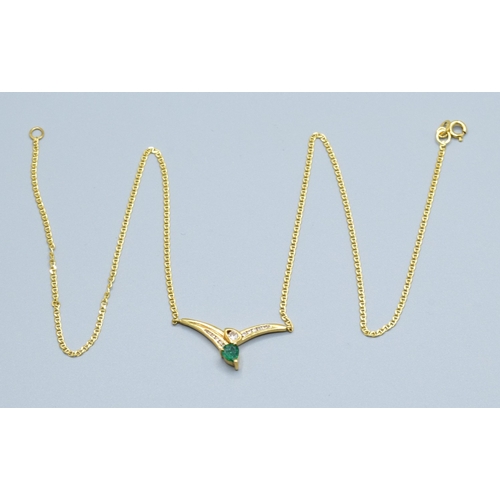 244 - 18ct gold ladies Diamond and Emerald cross over pendant necklace the pendant measures 30mm across by... 