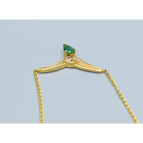 244 - 18ct gold ladies Diamond and Emerald cross over pendant necklace the pendant measures 30mm across by... 