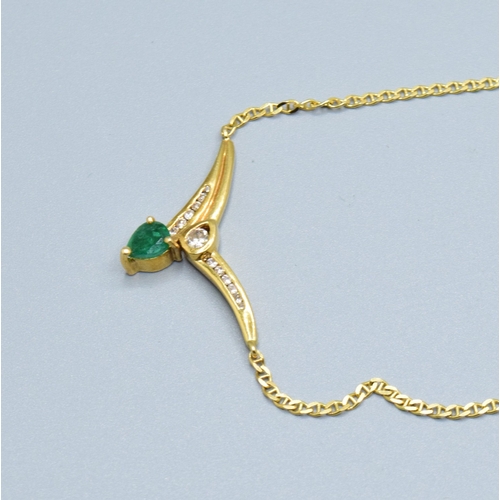 244 - 18ct gold ladies Diamond and Emerald cross over pendant necklace the pendant measures 30mm across by... 