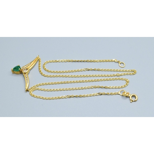 244 - 18ct gold ladies Diamond and Emerald cross over pendant necklace the pendant measures 30mm across by... 