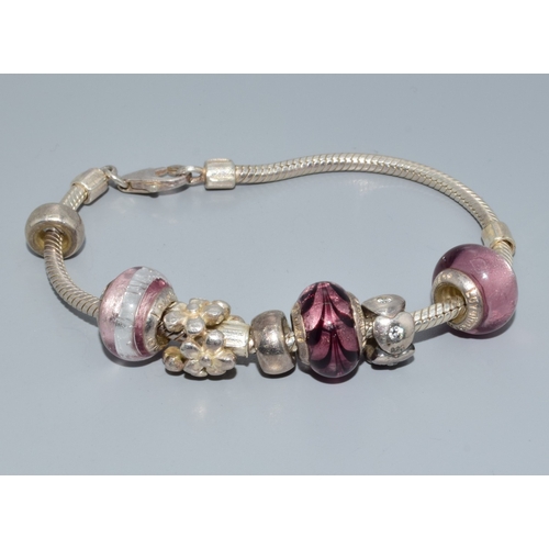 118 - Silver items to include a Pandora style bracelet. Silver agate pendant, a howling wolf silver pendan... 