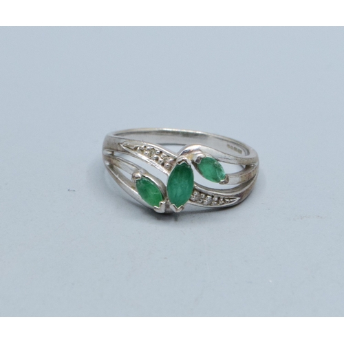 330 - 9ct white gold ladies Emerald and Diamond double sweep design ring size N, 3.4grams&nbsp;