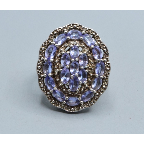 296 - Large oval Amethyst ladies statement ring set in an open work design in 925 silver the head size bei... 