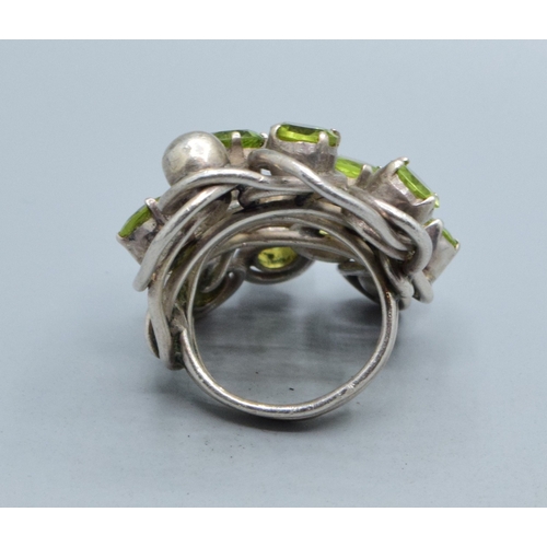 300 - Very large ladies Peridot multi stone statement ring held in an open design in 925 silver, the head ... 