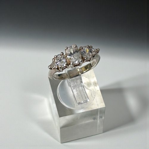19 - A sterling silver and clear stone trilogy ring.Size - N