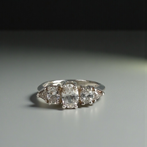 19 - A sterling silver and clear stone trilogy ring.Size - N