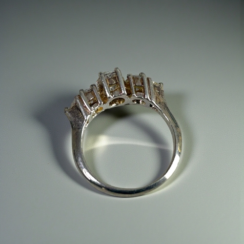 19 - A sterling silver and clear stone trilogy ring.Size - N